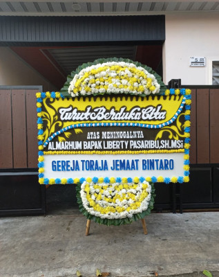 Papan Bunga Duka di Modelomo